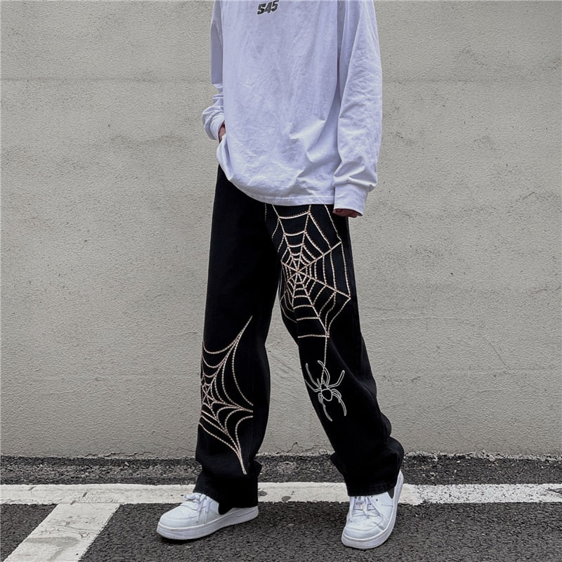 Sneaked - Pantalon Jean Y2K avec plusieurs toiles d'Araignées blanches sur les jambes