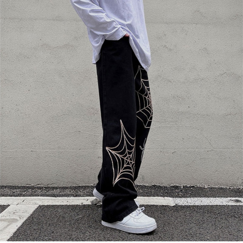 Sneaked - Pantalon Jean Y2K avec plusieurs toiles d'Araignées blanches sur les jambes